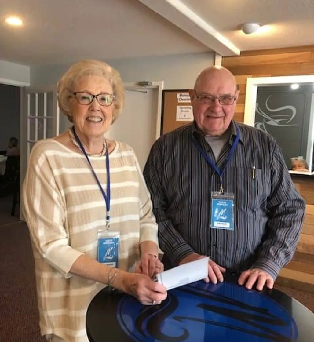 Morning Greeters handing shaking guest at Motion Church